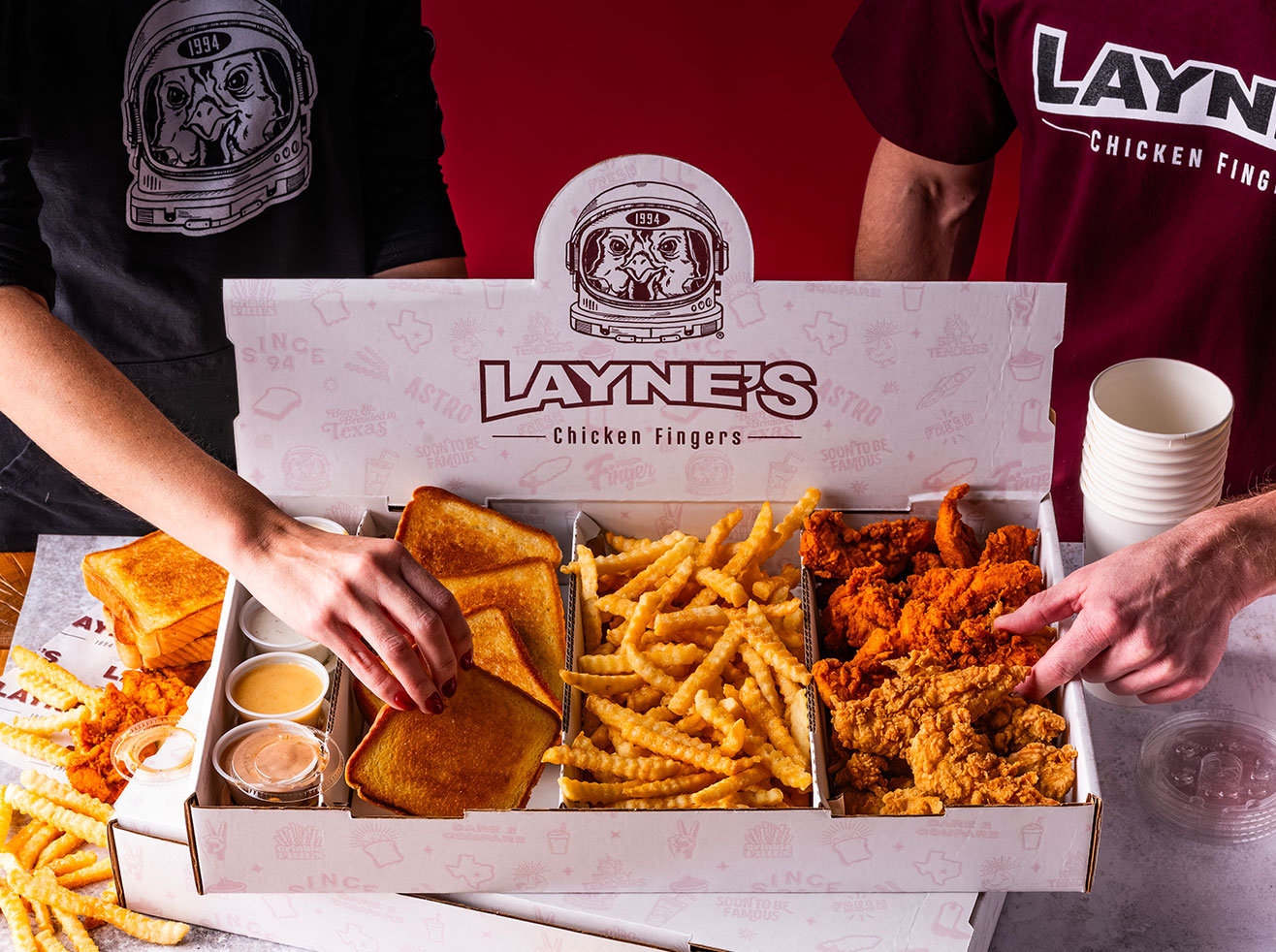 Layne's family pack with hands grabbing food